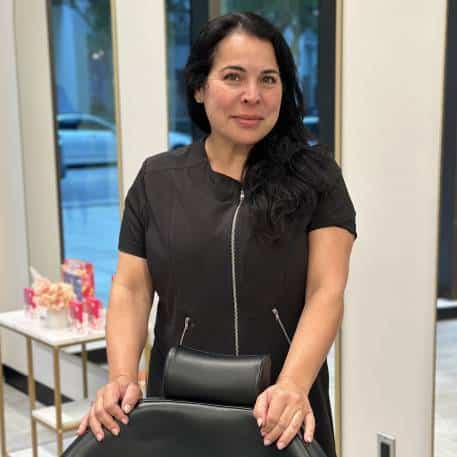 a woman standing in front of a window