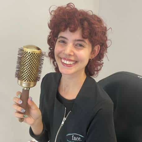 a person holding a microphone posing for the camera